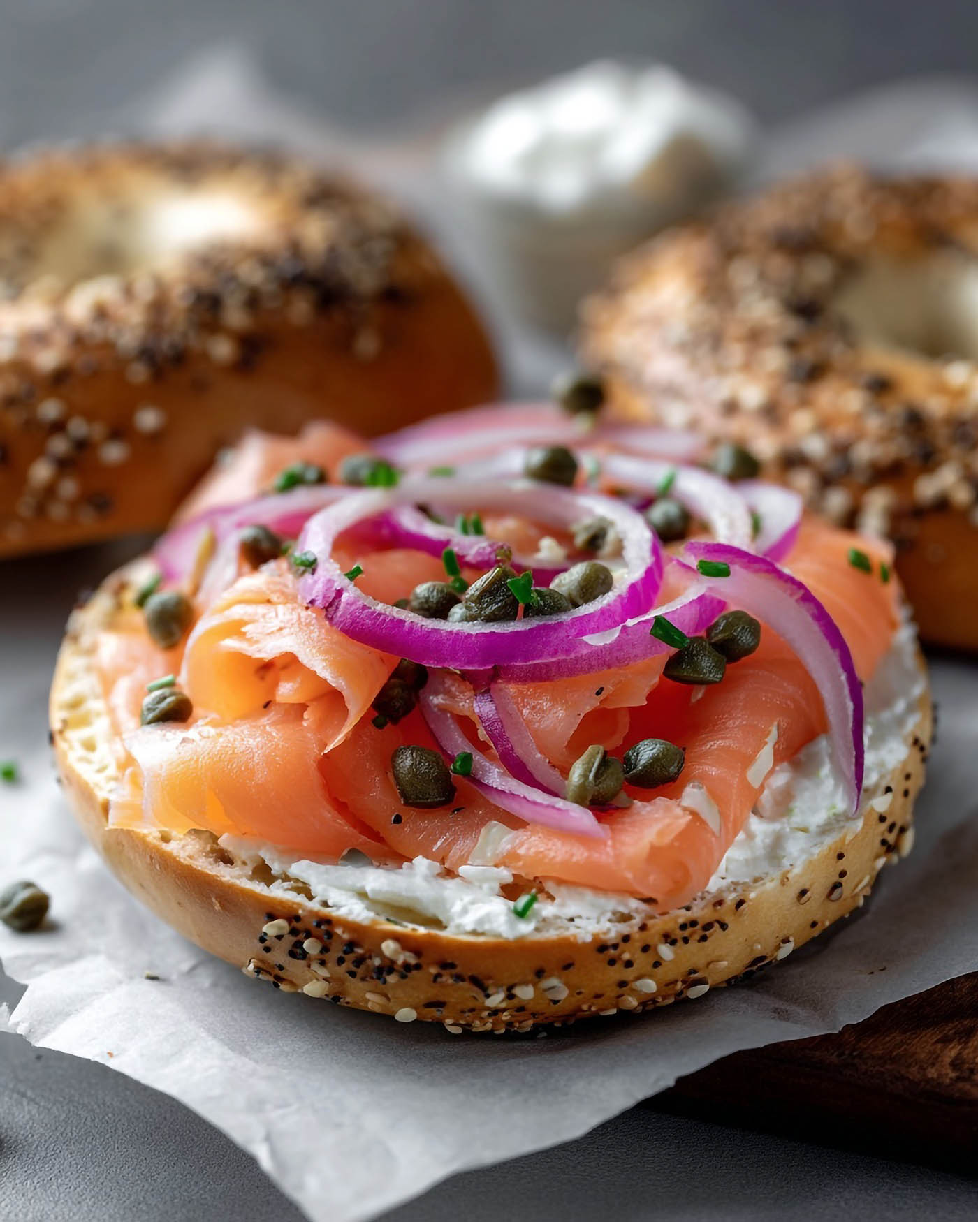 Open faced bagel with cream cheese salmon onion and capers